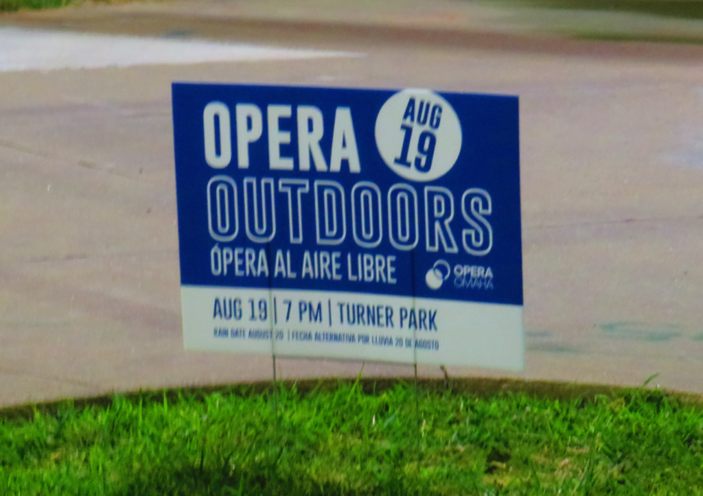 Sign for Opera Outdoors (Opera al Aire Libre) with text below