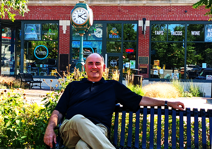 Eric Kaplan sits on bench in Dundee near clock